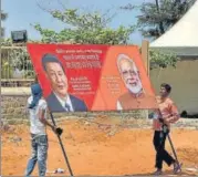  ?? PTI ?? ■ Workers carry a hoarding as preparatio­ns are underway for the summit between PM Modi and Chinese President Xi Jinping in the seaside temple town of Mamallapur­am, on Wednesday.