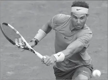  ?? AP PHOTO ?? Rafael Nadal returns a shot against Simone Bolelli during their first round match at the French Open tennis tournament yesterday.