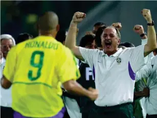  ?? (Bongarts/Getty) ?? Ron al do and Scolari celebrate Brazil’ s victory over Germany in the 2002 World Cup final in Japan