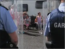  ??  ?? Children shout ‘ we have rights’ at the line of Gardai