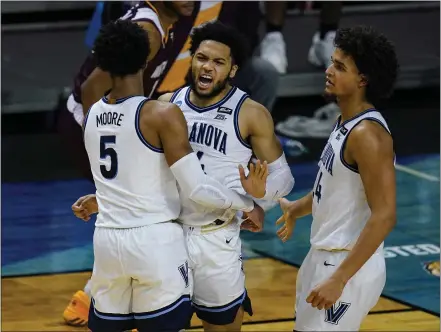  ?? MICHAEL CONROY — THE ASSOCIATED PRESS ?? NCAA Tournament rookies, from left, Justin Moore, Caleb Daniels and Jeremiah Robinson-Earl celebrate a defensive stop in the second half of Friday’s 73-63victory over Winthrop in the first round Friday night. The fifth-seeded Wildcats take on No. 13North Texas in the second round Sunday night.