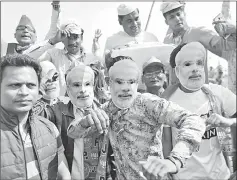 ??  ?? Supporters of India’s ruling Bharatiya Janata Party (BJP) are seen wearing masks of Modi at an election campaign rally in Meerut , Uttar Pradesh in this file photo. — Reuters photo
