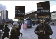  ?? KELVIN CHAN — THE ASSOCIATED PRESS ?? Rights campaigner Silkie Carlo, left, demonstrat­es in front of a mobile police facial recognitio­n facility outside a shopping center in London.