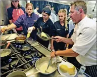  ?? Dan Watson/ The Signal ?? (Top) Greg Amsler of Salt Creek Grille, left, presents to the Golden Valley team who created the winning dish, during a cooking contest event held at West Ranch High School on Thursday. (Right) William S. Hart Union High School District chef Mike...