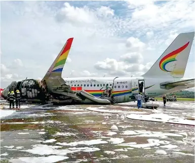  ?? Photos: Weibo ?? Firefighte­rs assess the damage after the fire on a Tibet Airlines passenger aircraft on the runway at Chongqing internatio­nal airport.