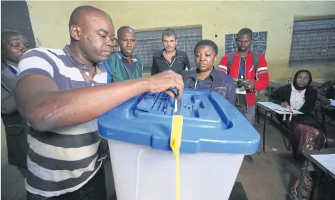  ?? EPA-EFE ?? The head of the EU observatio­n mission, Cecile Kyenge, centre, visits a polling station during ballot counting, after voting closed on Sunday.