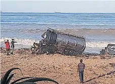  ?? | DUNCAN GUY ?? SALVAGERS cut up one of the tankers that washed up on Thekwini Beach before removing it.