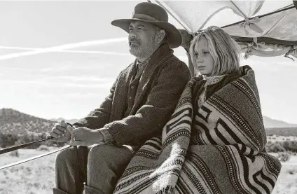  ?? Photos by Bruce W. Talamon / Associated Press ?? Tom Hanks, left, and Helena Zengel appear in a scene from “News of the World,” a film set in Reconstruc­tion-era Texas.