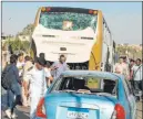  ?? Mohammed Salah The Associated Press ?? Police inspect a car and a bus that were damaged by a bomb Sunday in Cairo.