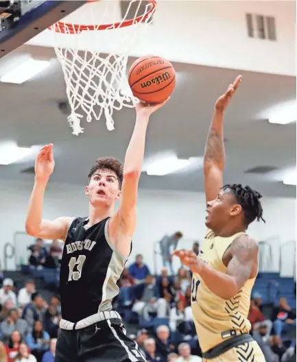  ?? MAX GERSH/THE COMMERCIAL APPEAL ?? Arlington's Madison Peaster (11) tries to block Houston's Mason Miller (13) during a Class AAA sectional on March 9.