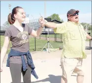  ??  ?? Gerry Nichols, right, Prairie Grove High School band director, shows Raimey McNatt what to do if someone grabs her arm during a station on self defense.