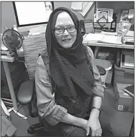  ?? Arkansas Democrat-Gazette/DEBRA HALE SHELTON ?? Nancy Allen, shown at her desk at the Faulkner County Library, wears a hijab in support of Muslim women. A hijab is a head covering worn by many Muslim women as a sign of modesty.