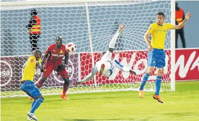  ?? Picture: MICHAEL PINYANA ?? UPSIDE DOWN ATTACK: Chippa United’s Rhulani Manzini tries a bicycle kick as Mamelodi Sundowns goalkeeper Denis Onyango, in red, and his defenders Anele Ngcongca, left, and Ricardo Nascimento react to clear the ball out of danger.