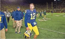  ?? TONY DING, AP ?? Michigan punter Blake O’Neill leaves the field after his botched kick led to Michigan State’s victory Saturday.