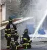  ?? Getty Images ?? Firefighte­rs extinguish a blaze caused by gas lines in Lawrence, Mass.