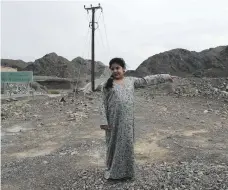  ?? Pawan Singh / The National ?? Top, school buses cross the wadi, centre, in Marbad, Fujairah; Ghaya Al Dahmani was one of 600 pupils stranded at Al Ansari Primary School by storms on Sunday