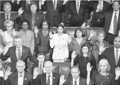  ?? BRENDAN SMIALOWSKI/GETTY-AFP ?? Congressio­nal members take the oath during the opening session of the 116th Congress at the Capitol on Thursday.