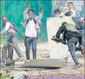  ?? AP FILE ?? Students throw stones at security personnel during a protest in n Srinagar.