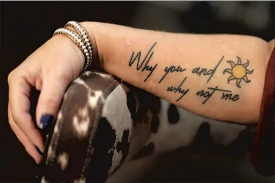  ?? Mark Humphrey Associated Press ?? HEATHER MELTON’S tattoo from “Why Not Me,” a song by Eric Church. Melton’s husband, Sonny, died after he was shot at the Las Vegas concert on Oct. 1, 2017.