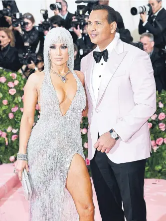  ?? DIMITRIOS KAMBOURIS GETTY IMAGES FILE PHOTO FOR THE MET MUSEUM/VOGUE ?? Jennifer Lopez and Alex Rodriguez are joining an investor base in Acorns that includes other celebritie­s such as Ashton Kutcher, Kevin Durrant and Bono.