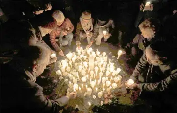  ??  ?? People light candles at the site of a former synagogue in Schwerin as Germany marks the 80th anniversar­y of the ‘Night of Broken Glass’ (Kristallna­cht). — AFP photo