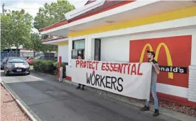  ??  ?? BEN MARGOT Protesting what they say is a lack of personal protective equipment, employees close the drive-thru at a McDonald's in Oakland, Calif., last month.