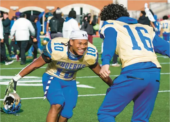  ?? RENE SHELTON/FREELANCE PHOTOS ?? Phoebus’ Kaleb Tillery, left, and Adonis Stowers celebrate after the team defeated Salem 21-14 to win the Class 4 state championsh­ip game Saturday at Williams Stadium in Lynchburg.