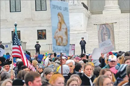  ?? Roberto Schmidt AFP/Getty Images ?? ANTIABORTI­ON advocates march past the U.S. Supreme Court building during the annual March for Life in Washington on Friday.