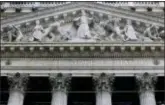  ?? RICHARD DREW — THE ASSOCIATED PRESS FILE ?? This photo shows the facade of the New York Stock Exchange. U.S. stocks mostly rose Thursday, as markets get accustomed to the idea of investing with less of a safety net from central banks around the world.