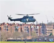  ?? ?? An RAF helicopter circles Hampstead Heath, while officers in Hazmat suits, top, join the search for Abdul Ezedi, right, in east London