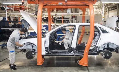  ??  ?? Workers assemble a car for FAW-Volkswagen, one of the German firm’s joint ventures in China. Photograph: Xinhua/Rex/Shuttersto­ck