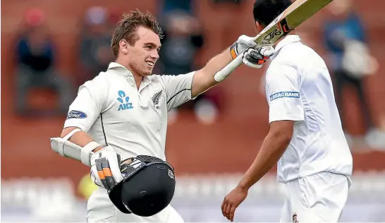  ?? GETTY IMAGES ?? Tom Latham celebrates his century at the Basin Reserve in Wellington yesterday. The opener finished the day unbeaten on 119.