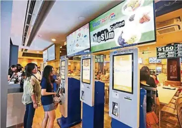  ??  ?? Coffee shops in Singapore now offer innovation­s such as trayreturn robots, digital ordering and cashless payment options. — ANN