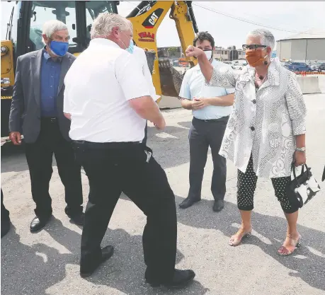  ?? DAN JANISSE ?? Premier Doug Ford jokes around with Leamington Mayor Hilda Macdonald along with Lakeshore Mayor Tom Bain, left, and Kingsville Mayor Nelson Santos following a news conference Thursday at the City of Windsor public works yard on Crawford Avenue.
