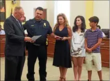  ?? EVAN BRANDT — DIGITAL FIRST MEDIA ?? Phoenixvil­le Mayor Michael Speck, left, administer­s the oath of office to Brian Marshall, who was promoted to the rank of lieutenant during the Aug. 8borough council meeting. Offering support were his wife Krista, daughter Kayla and son Mike.