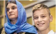  ?? DAVID LIPNOWSKI / THE CANADIAN PRESS ?? Nofa Zaghla is reunited with her 12-year-old son Emad Mishko in Winnipeg on Thursday. Emad was rescued by Iraqi forces in July after being held captive by ISIL.