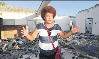  ?? PICTURES: LEON LESTRADE ?? TOTAL DESTRUCTIO­N: Standing in rubble in the derelict remains of what was once the old Bonteheuwe­l Post Office, Judy Kennedy of the Bonteheuwe­l Joint Peace Forum says the community will fight to restore dignity to the gang-ridden area.