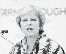  ?? MATT CARDY GETTY IMAGES ?? British Prime Minister Theresa May arrives to deliver a speech as she opens the Farnboroug­h Airshow on Monday in Farnboroug­h, England.