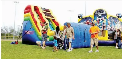  ?? SUBMITTED ?? Children play on the inflatable­s at last year’s Quitmanfes­t. The event will take place from 10 a.m. to 8 p.m. Saturday and feature live entertainm­ent, activities for kids, contests, vendors and a car show.