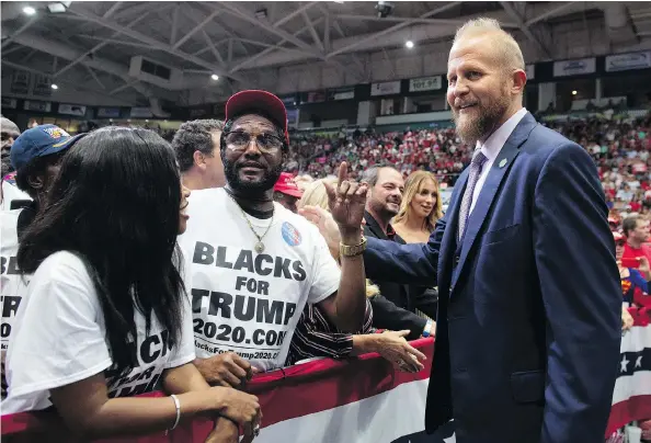 ?? SAUL LOEB/AFP/GETTY IMAGES ?? Brad Parscale, right, re-election campaign manager for U.S. President Donald Trump, speaks with supporters at a campaign rally in Estero, Fla., in October.