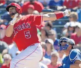  ?? Matt York Associated Press ?? ALBERT PUJOLS hits a home run against the Dodgers in mid-March, one of two home runs this spring training by the Angels first baseman and designated hitter.