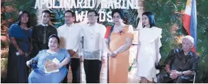  ??  ?? JOSELYN Rosemarie Cris Cevallos-Garcia, EVP and COO of Tahanang Walang Hagdan (seated in blue), was given the Mabini Presidenti­al Award, the highest recognitio­n given by the Apolinario Mabini Awards. With her in the photo are her family (L to R); Arch. Jaime Silva, chairman of the Apolinario Mabini Awards Screening Committee; Lourdes de la Llana-Pimentel, chairwoman of the Apolinario Mabini Awards; Usec. Aimee Neri of the DSWD; and Manuel Agcaoili, president of the Philippine Foundation for Rehabilita­tion of the Disabled, Inc.