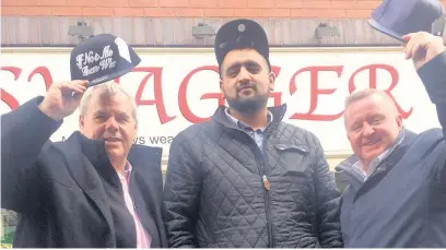  ??  ?? ●●Council Leader Richard Farnell, shop owner Ali Hasan and Town Centre Manager Mark Foxley celebrate the success of Swagger menswear shop in Rochdale town centre