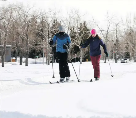  ?? DARREN MAKOWICHUK ?? Madyson McKay and Hailey Doney cross-country ski at Confederat­ion Park. February has had nine days of measurable snowfall. .