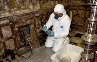  ??  ?? Right: The author removing relics from the casket inside a small alcove in the chancel
Below: Saint Eanswythe’s Chapel on the south side of the chancel features windows by Gerald Edward Roberts Smith (1883–1959); here Eanswythe makes a stream run uphill to her nunnery (c 1955)