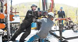  ?? RALPH WILSON/AP 2010 ?? Workers move a section of pipe at a Chesapeake Energy natural gas well site in Pennsylvan­ia. The company, saddled with nearly $9 billion in debt, filed for bankruptcy Sunday.