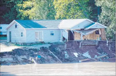  ?? Jake May The Associated Press ?? Floodwater­s tore through a house with its remains seen Wednesday in the Edenville Township north of Midland, Michigan.