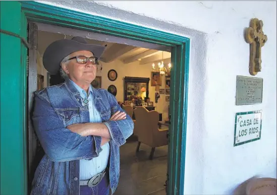  ?? Mark Boster For The Times ?? LAWYER Stephen Rios, whose family worked for the Moultons and O’Neills, stands in the doorway of the adobe house in San Juan Capistrano built by his family in the 1780s. The Rios Adobe is the the oldest continuous­ly inhabited home in California and a huge part of the history and culture of Orange County.