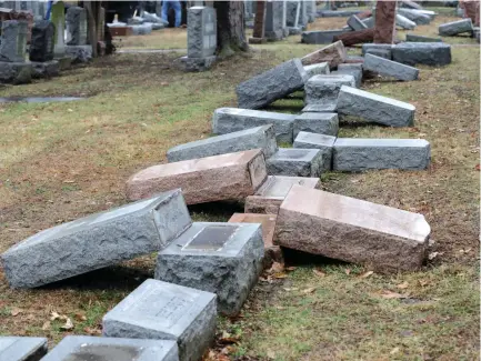  ?? (Reuters) ?? A ROW of more than 170 toppled Jewish headstones is seen after a weekend vandalism attack on Chesed Shel Emeth Cemetery in University City, a suburb of St Louis, Missouri, in February.