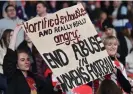  ?? England. Photograph: Glyn Kirk/AFP/Getty ?? Supporters hold a banner in support of players during the USA’s game against